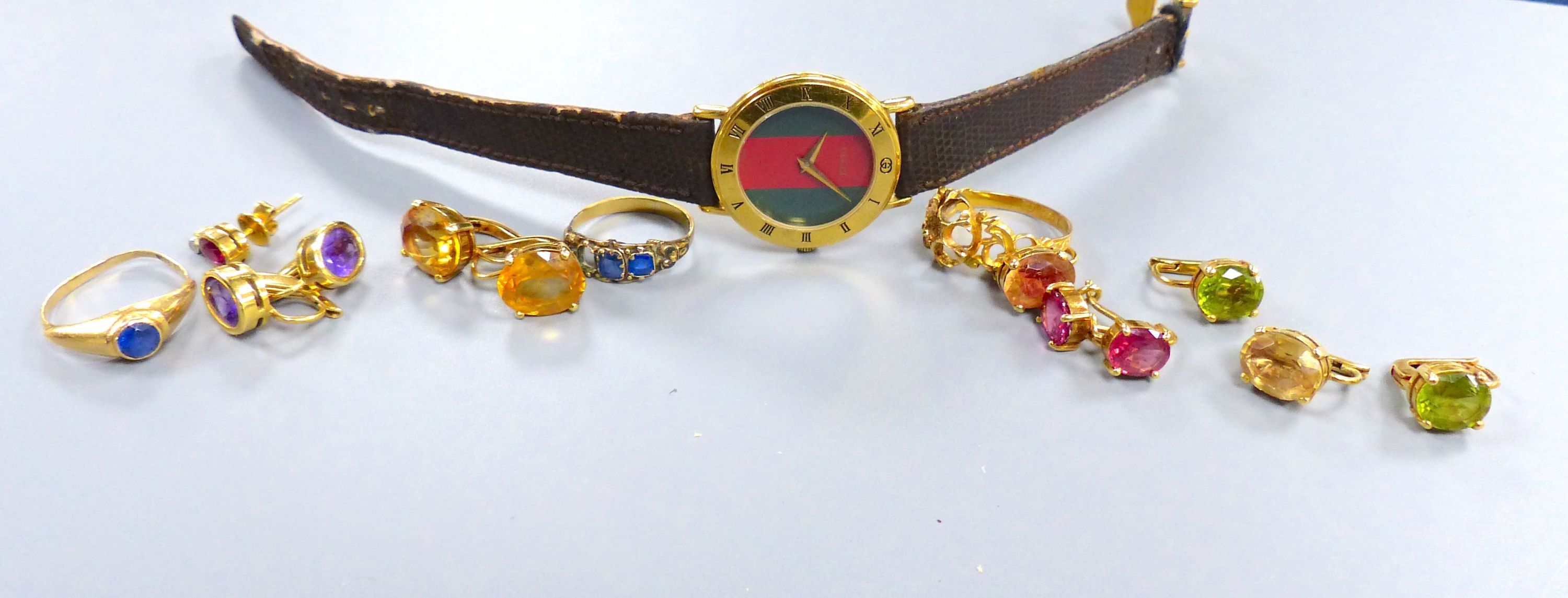 Five pairs of yellow metal and gem set earrings, gross 20.3 grams, three assorted yellow metal rings(a.f.) and a watch.